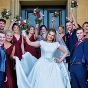 Relaxed pose on the venue's steps with the newlyweds and their bridal party - the smiles in this capture make it extra special and fun