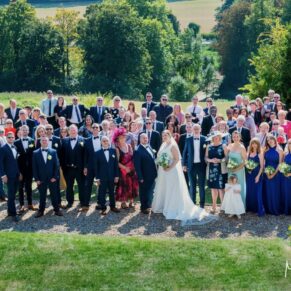 Photography of everyone captured from up high at the Latimer Estate for this summer wedding celebration with distant views of the Chess Valley in the distance  