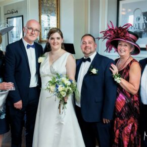 Small group pose captured with stunning window light in the bar area of the hotel