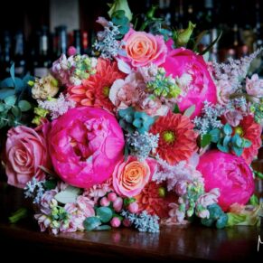 Vibrant summer bouquet captured with gorgeous window lighting at the Latimer Estate 