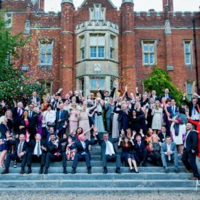 Large group pose on the grand steps within the gardens of the Latimer Estate 