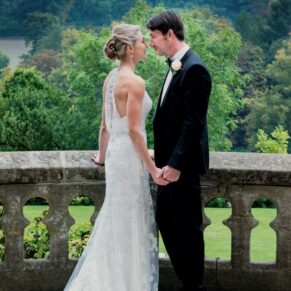 Romantic pose of the newlyweds on the hotel terrace at their Latimer Estate summer wedding 
