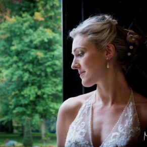 Dramatic pose of the bride in the entrance doorway on the Latimer Estate 