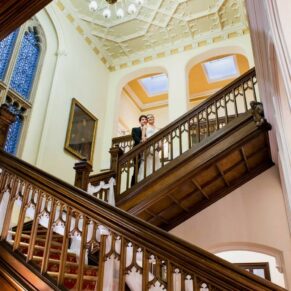The newlyweds on the fabulous staircase inside the main house on the Latimer Estate 