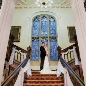 The newlyweds strike a pose on the grand staircase in the main house 