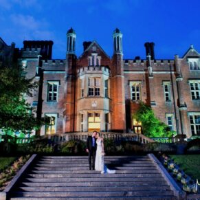Dramatic dusk pose of the bride and groom outside the hotel on the grand steps at their Latimer Estate wedding 