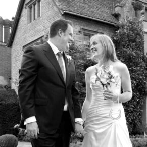 The newlyweds outside the hotel in a casual pose at Le Manoir Aux Quat Saisons 