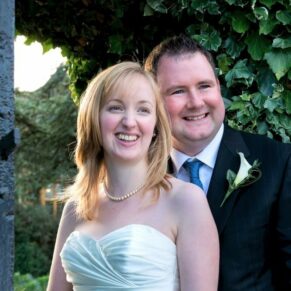 The newlyweds pose for the camera in a close-up pose in the gardens of their Le Manoir Aux Quat Saisons wedding 