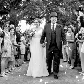 Micklefield Hall Wedding Photography - confetti aisle capture withy the newlyweds loving every moment 