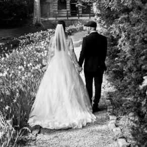 The newlyweds take a stroll through the gardens towards the summerhouse at their Buckinghamshire venue 