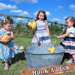 Notley Tythe Barn Wedding Photography - vintage fairground games being enjoyed by these young guests 