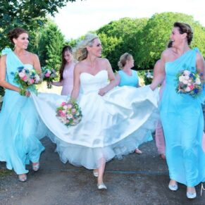 Notley Tythe Barn Wedding Photography - the bride and her bridesmaids take a stroll through the grounds