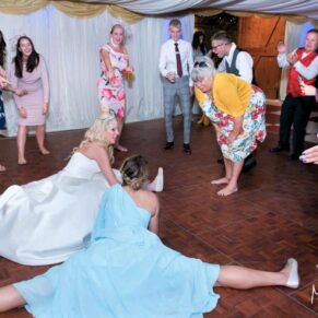 Notley Tythe Barn Wedding Photography - crazy dance moves from  the bride and her bridesmaid