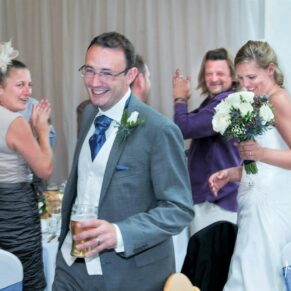 Odney Club Wedding Photography - the cheering entrance into the meal for the bride and groom