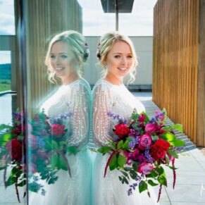 Dramatic bridal portrait captured at Windmill Hill on the Waddesdon Estate with distant views and reflections used to great effect 