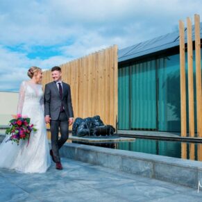 Five Arrows Hotel - Buckinghamshire Wedding Photographer - the newlyweds strolling amongst the modern architecture of Windmill Hill on the Waddesdon Estate