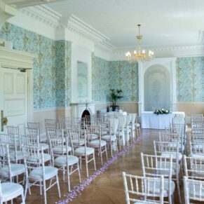 Striking setup for the eighty guest indoor civil wedding ceremony in the Oak Room at Pendley Manor Hotel in Hertfordshire