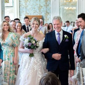 The bride with her father entering the indoor civil wedding ceremony at Pendley Manor Hotel 