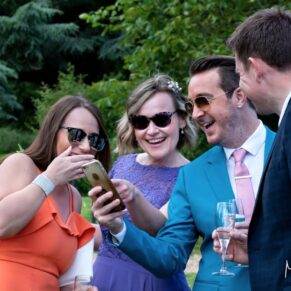 Informal capture of some wedding guests in the gardens during the drinks reception at Pendley Manor Hotel 