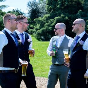 The boys enjoying the banter during the outdoor wedding drinks reception in the wonderful Pendley Manor Hotel gardens 