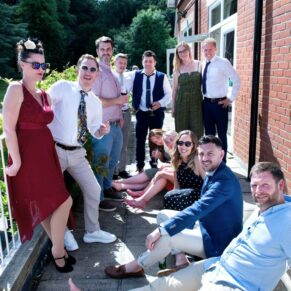 Wedding guests relaxing on the terrace during the drinks reception at Pendley Manor Hotel 
