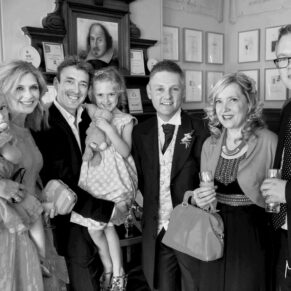 Wedding guests pose for the camera in the bar area at Pendley Manor Hotel 