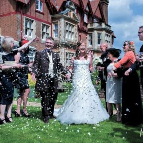 Fun confetti moment during the drinks reception for the bride and groom at their at Pendley Manor Hotel wedding 