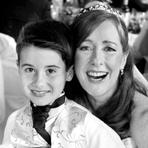The bride captured informally with her son during the meal at her Pendley Manor Hotel wedding 