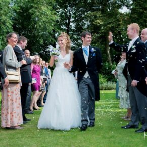 Runnymede Hotel Wedding Photography - the newlyweds make their way through the confetti aisle 