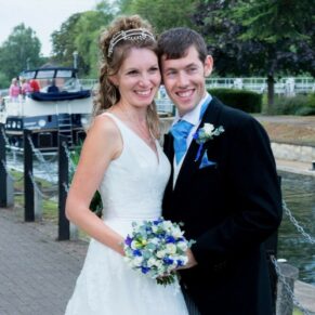 Runnymede Hotel Wedding Photography - the newlyweds pose for a portrait beside the river