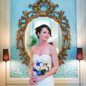 Sir Christopher Wren Hotel Wedding Photography - the bride captured beside an ornate mirror inside the hotel
