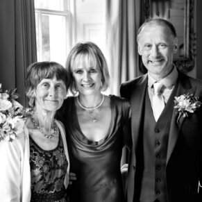 The bride and groom captured with mum by windowlight at their Saint Michael's Manor wedding 