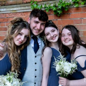 The bridesmaids and the best man in the Tudor Barn folly strike a pose for the camera