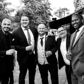 Guests enjoying the outdoor drinks reception at the Tudor Barn 