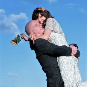 A fun and embracing hug from the bride and groom at their glorious Tudor Barn wedding  