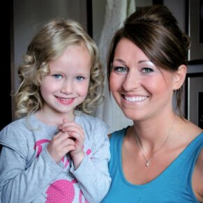 Wokefield Estate Berkshire Wedding Photography - the bride with her flowergirl smile for the camera