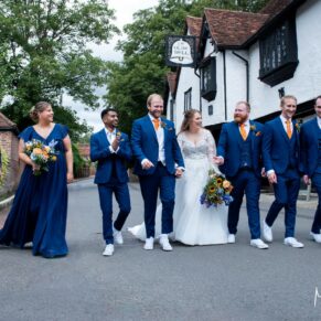 The relaxed wedding bridal party take a stroll outside the Olde Bell Hotel in Hurley after the civil ceremony