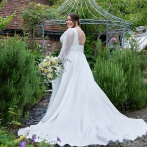 The bride poses for the camera in the wonderful summery gardens at her Olde Bell in Hurley wedding
