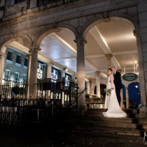 Photography of the newlyweds captured under the arches of the Guildhall in Windsor after dark on their Castle Hotel wedding day 