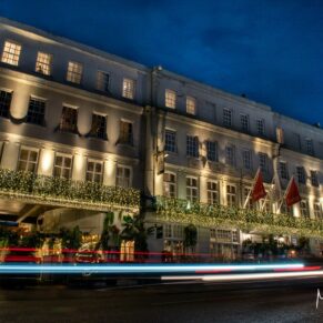 Photography of the Castle Hotel exterior in Windsor captured at night time with moving car headlights for this Christmas wedding 