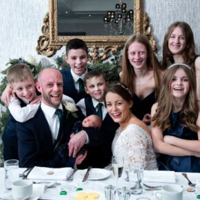 Photography of the newlyweds d with their children during the meal at their Castle Hotel wedding in Windsor 