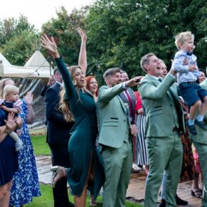 Guests larking around for the videographer during the drinks reception