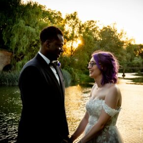 A silhouette pose of the newlyweds on their wedding day as the sun sets over the River Thames at The Great House in Sonning
