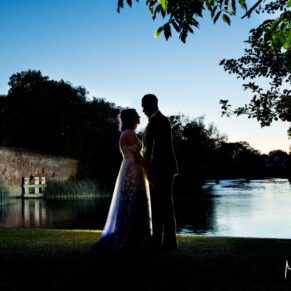 When night time arrived, I brought out my floodlighting for some dramatic poses of the newlyweds at this Sonning wedding. For this silhouette pose captured in at the water's edge, I took the couple near to the bridge at dusk. I'm using multiple lights to achieve the striking pose you see here, the lighting has been used to great effect on the bridge especially. Dramatic evening silhouette shot of the newlyweds next to the River Thames at their Great House in Sonning wedding