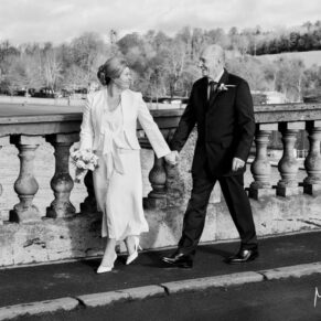 The bride and groom enjoy a walk over the historic bridge in the town before their Hotel Du Vin Henley wedding reception