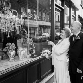The bride and groom go window shopping in the town before their Hotel Du Vin Henley wedding reception