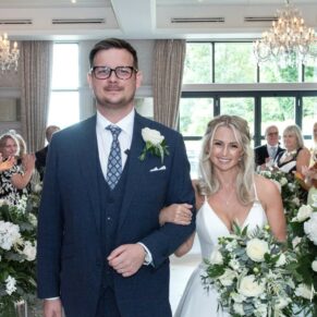 The smiling bride and groom exit the indoor civil ceremony at their Latimer Estate wedding