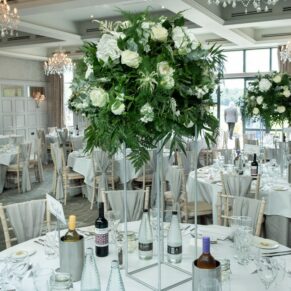 Photography of stunning white wedding floral arrangements inside the Cavendish Suite on the Latimer Estate 