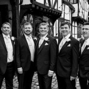 The groom and the lads gather for a photo in the High Street outside the Kings Chapel before the wedding ceremony 