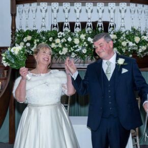The newlyweds exit their ceremony at their Kings Chapel wedding reception in Old Amersham